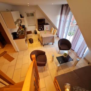 an overhead view of a living room with a table and chairs at Ferienwohnungen Saida Wohnung 12 in Norden