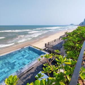 an overhead view of a swimming pool and the beach at M SUITE Danang Beach in Da Nang