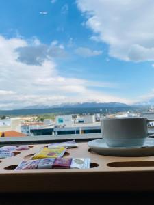a cup of coffee sitting on top of a table at Hakcan Hotel in Izmir