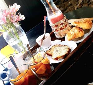 a tray of food with bread and pastries and drinks at The first real Bed & Breakfast Hiking Hotel 'The Office' in Arequipa, Peru in Arequipa