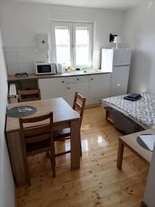 a kitchen with a table and chairs and a dining room at martin1 in Slavonski Brod +26 photos