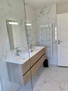 a bathroom with a sink and a mirror at Dans ma Bulle - Les Balcons de la Cité in Carcassonne +39 photos