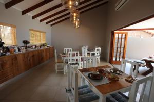 Rhino Coast Guesthouse في سانت لوسيا: مطبخ وغرفة طعام مع طاولة وكراسي
