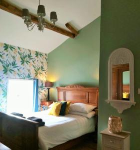 a bedroom with a bed and a green wall at Beautiful 2 bed cottage with swimming pool in Pagéas