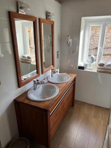 a bathroom with two sinks and a mirror at Chambres d'Hôtes Mado et Lulu in Collonges-au-Mont-dʼOr