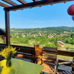 a table and chairs on a balcony with a view at Brvnara Vrdnik in Vrdnik