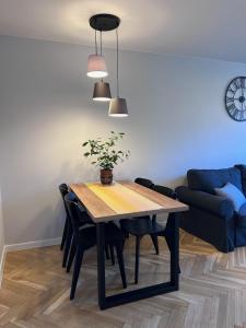 a dining room table with a potted plant on it at Apartament Wspomnienie in Duszniki Zdrój