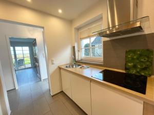 a kitchen with a sink and a counter top at Haus am Wattenmeer Watt n Idyll in Rantum