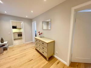 a room with a dresser with a mirror on the wall at Norderhof Kliffsand 15 in Kampen +22 photos