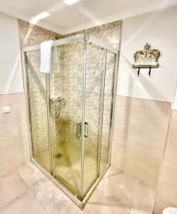 a shower with a glass door in a bathroom at Hostal Boutique Plaza Cantarero in Nerja