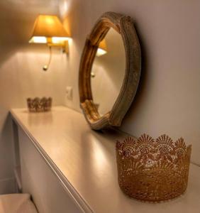 a mirror sitting on a counter in a bathroom at Hostal Boutique Plaza Cantarero in Nerja