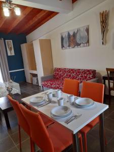 a living room with a table with chairs and a couch at Victory Apartments Hotel in Samothráki