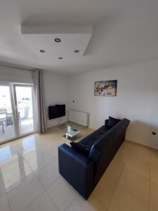 a living room with a couch and a tv at Apartments Daniel in Vodice