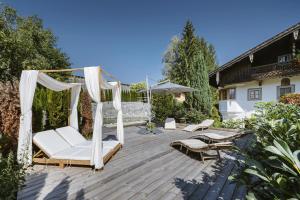 a patio with a gazebo and a swing at Bauernhaus-Schloss Wagrain in Ebbs