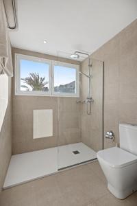 
a bathroom with a toilet, tub, sink and shower at La Moraleja The Quiet Hotel in Cala de Sant Vicenc
