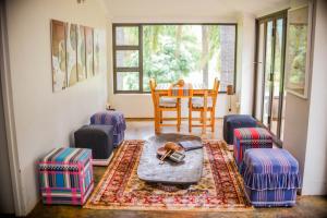 a living room with a table and chairs at Madi a Thavha Mountain Lodge in Louis Trichardt
