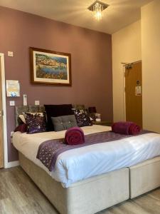 a bedroom with a large bed in a room at The Quies in Newquay