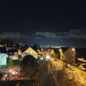 a view of a city at night with lights at Pension Bad Soden / Apartment and Rooms in Bad Soden am Taunus
