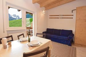 a living room with a table and a blue couch at Aurturist Sesto in Sesto