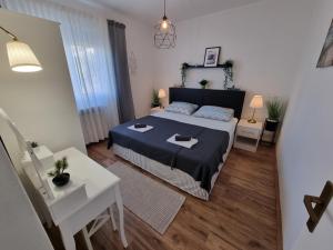 a bedroom with a bed with a blue bedspread at Apartment ANAMARIJA BR. 1 in Crikvenica