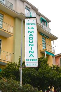 a hotel sign in front of a building at HOTEL LA MADUNINA in Varazze