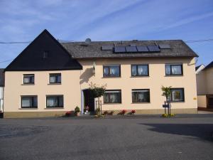 a house with solar panels on the roof at Ferienhaus Lenartz in Kliding