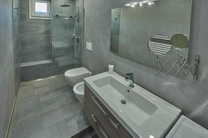 a bathroom with a sink and a shower and a toilet at Lake Mirror in Lezzeno