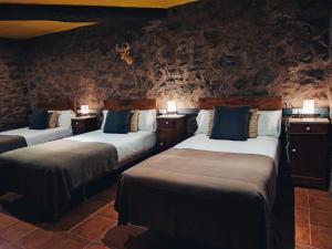 Gulta vai gultas numurā naktsmītnē Hotel Rural Curia