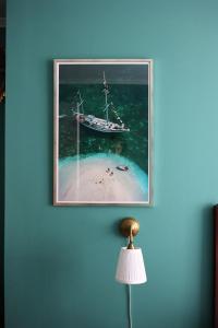 a picture of a boat in the water on a wall at SOFS boutique hotel in Aarhus