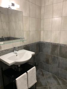 a bathroom with a sink and a mirror at ARTE Hotel rooms & apartments in Veliko Tŭrnovo