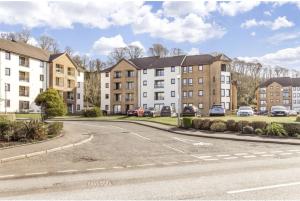 an empty street in front of some buildings at Bellevue Apartment in Largs