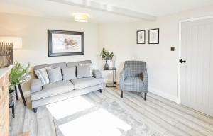 a living room with a couch and a chair at Host & Stay - 19 West End in Hurworth