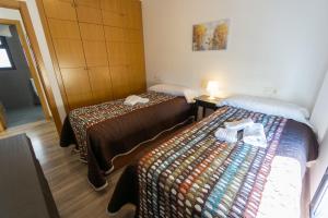 A bed or beds in a room at RentalSevilla Virgen de Loreto