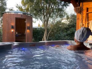 a person in a jacuzzi in a hot tub at Wellness Bungalow Bolder 5p Amsterdam and the beach in Opmeer