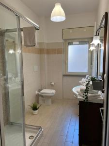 a bathroom with a shower and a toilet and a sink at La Torretta in LʼAquila