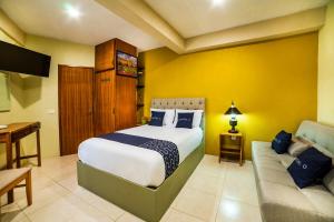 a bedroom with a bed and a couch at Casa Santa Fe, Guanajuato in Guanajuato