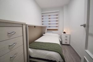 a small bedroom with a bed and a window at Apartamento Encanto Tarazona in Tarazona de Aragón