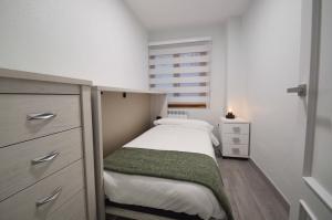 a small bedroom with a bed and a window at Apartamento Encanto Tarazona in Tarazona de Aragón