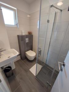 a bathroom with a shower and a toilet and a sink at Apartments Daniel in Vodice +56 photos