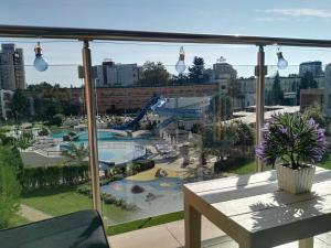 een balkon met uitzicht op een zwembad en een speeltuin bij Apartment Konstantin in Trakia Plaza in Sunny Beach