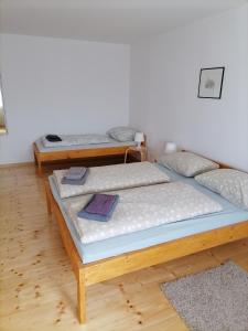 2 camas individuais num quarto com pisos em madeira em martin1 em Slavonski Brod