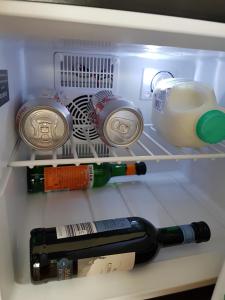 a refrigerator filled with lots of bottles of wine at Petite Anchorage in Christchurch