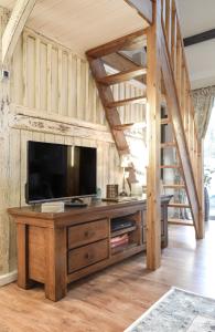 sala de estar con TV de pantalla plana sobre una mesa en The Old Milking Parlour, en Llandovery