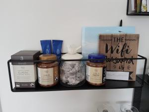 a shelf with spices and a box on it at Petite Anchorage in Christchurch