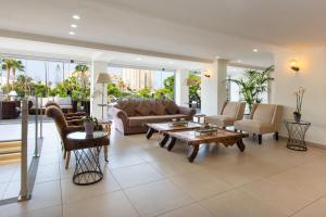 a living room with a couch and a table at Olé Tropical Tenerife Adults Only in Playa de las Americas
