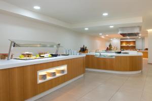 a kitchen with a counter with food on it at Olé Tropical Tenerife Adults Only in Playa de las Americas