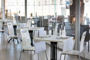 a row of tables and chairs in a restaurant at Olé Tropical Tenerife Adults Only in Playa de las Americas