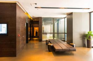 a lobby with a bench in a building at Empire Hotel Causeway Bay in Hong Kong
