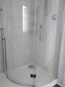 a shower with a glass door in a bathroom at 1 Double room with shared bathroom in Bracknell