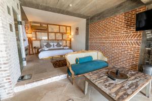 a room with a bed and a couch and a table at Ölüdeniz Loft - Adults Only in Oludeniz